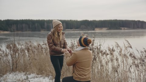 A guy making a proposal to his girlfriend. Family, marriage,love concept. Filmed on cinema camera. 12 bit color space.