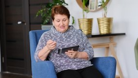old woman communicates via video link with family and friends from home. self-isolation