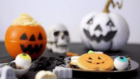 Woman takes cookie from halloween party table - Powered by Shutterstock - Get 15% off with code: PIKWIZARD15