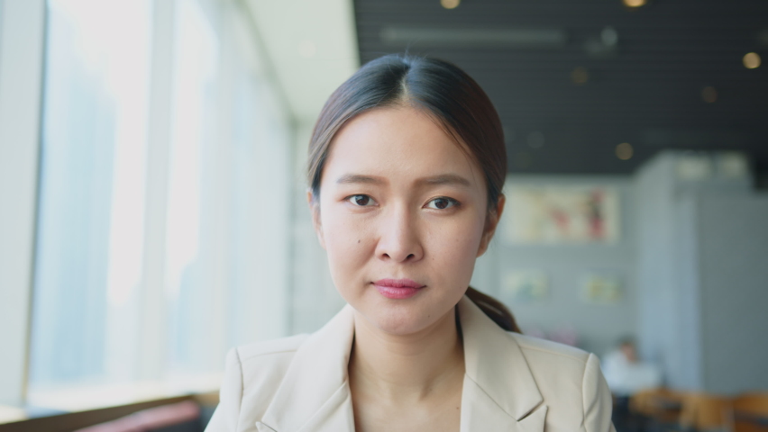 Portrait young beautiful Asian business woman in casual suit look at camera and smile | Shutterstock HD Video #1061602198