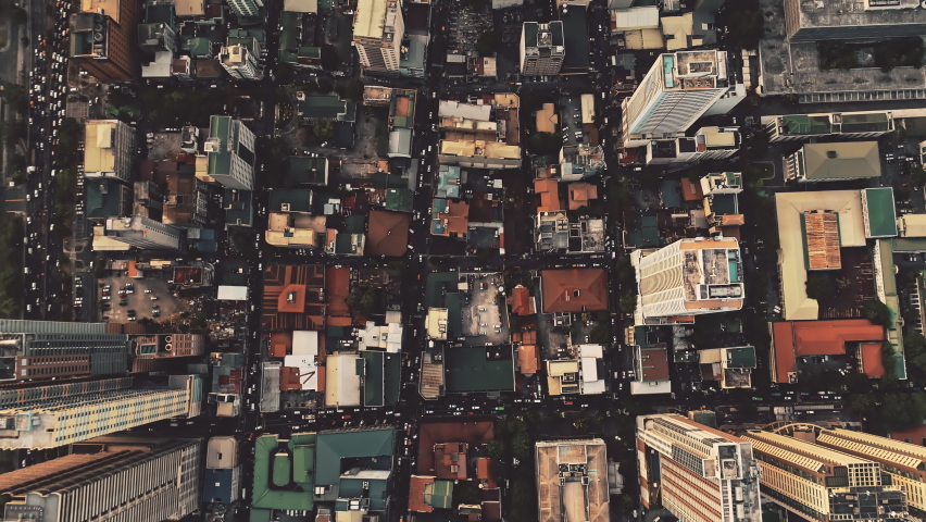 Top down of skyscrapers roofs aerial. Manila metropolis city architecture at downtown streets. Majestic cityscape of Philippines capital town. Traffic roads with cars at block houses, cottages
