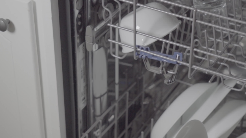 Top rack of dishwasher loaded with drinking glasses being pulled out. Royalty-Free Stock Footage #1061606938