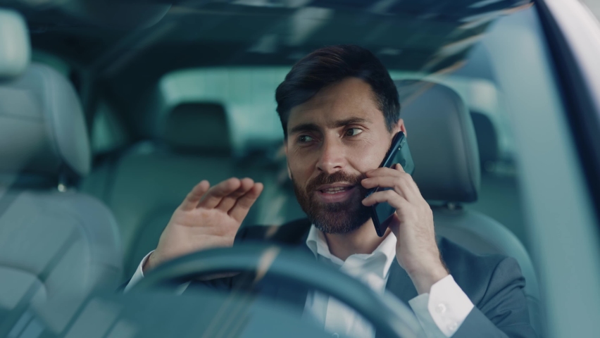 Euphoric excited adult caucasian businessman talking on the mobile phone learning great news celebrating business victory achievement goals cheer up sitting in car. Person success. Royalty-Free Stock Footage #1061608750