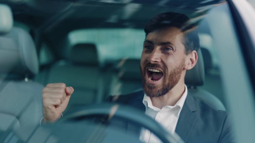Euphoric excited adult caucasian businessman talking on the mobile phone learning great news celebrating business victory achievement goals cheer up sitting in car. Person success. | Shutterstock HD Video #1061608750