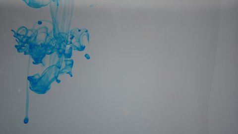 One ink flow, infusion blue dye cloud or smoke, ink inject on white in slow motion. Blue tint splatter in water. Inky background or smoke backdrop