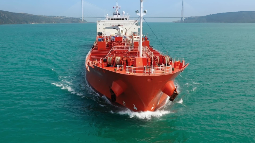 Slow Mo. A red oil tanker underway through Bosphorus Strait. Prow, upper deck, pipe lines and winches of tanker ship. Approximately 55000 vessels transit annually in Turkish Straits. Close up, Aerial
 Royalty-Free Stock Footage #1061617120