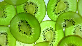 Top view Rotate of Transparent Slice of kiwi fruit  on white background, Close up fresh kiwi sliced on white background and slowly rotating.