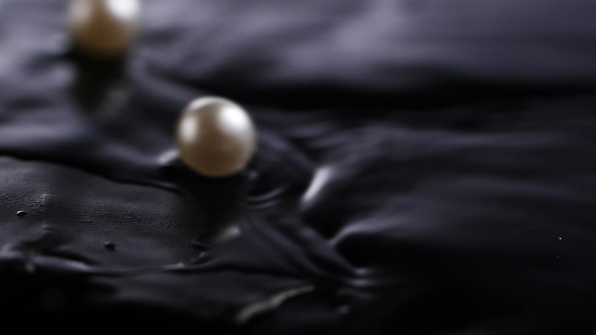 Beautiful white pearls in the dark water Royalty-Free Stock Footage #1061617225