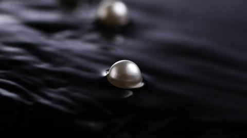 Beautiful white pearls in the dark water