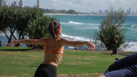 Yoga Instructor Stretching And Exercising At The Park - Yoga At Beach - Burleigh Heads Beach In Summer - Gold Coast, Queensland, Australia. -medium shot