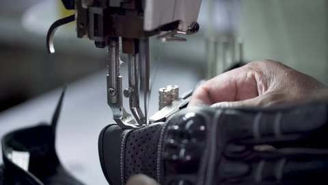 Closeup Shot Of Tailor Stitching And Cutting Leather In A Sweatshop Factory