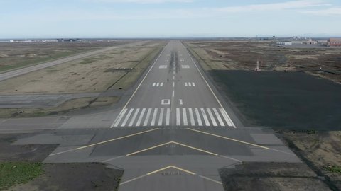 Forward aerial of airstrip in Iceland with POV arrival flight line