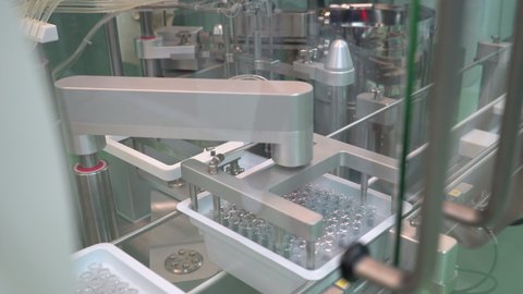 Pharmaceutical manufacturing line automatic machine. Covid-19 coronavirus vaccine Production equipment at pharmacy medical industry. vials ampules vaccines vaccine viruses medicine healthcare medicine