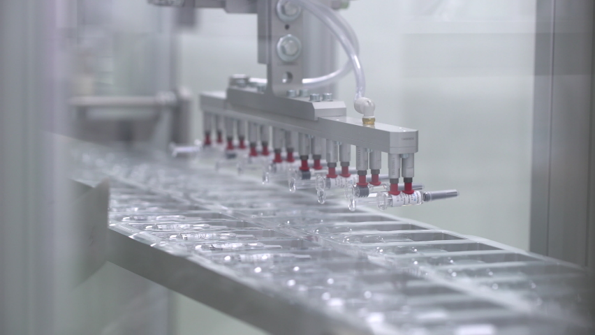 Pharmaceutical manufacturing line automatic machine. Covid-19 coronavirus vaccine Production equipment at pharmacy medical industry. vials ampules vaccines vaccine viruses medicine healthcare medicine