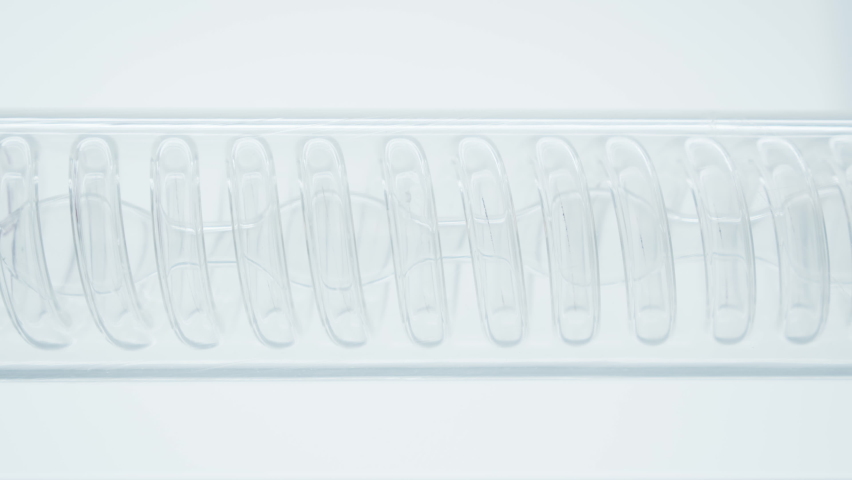 The flask is a tube with a spiral inside. Chemical reactions. Scientific experiment. Red liquid or blood flows in a spiral into the flask. Filtration process.