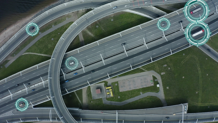 Top down aerial drone view of autonomous self driving cars moving through city Spbd. traffic on junction. Artificial intelligence in automotive industry. contol concept