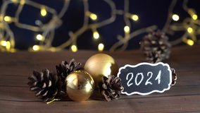 2021 video New Year's Eve Bokeh, Pine cones Composition with Text Mock-up Evening Dark Flashlights, Christmas tree lights - Powered by Shutterstock - Get 15% off with code: PIKWIZARD15