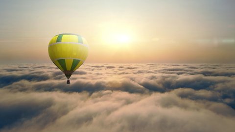 Aerial view Balloon flying at sunset over the clouds. Balloon flight above the clouds. The sun's rays illuminate the clouds and fog at sunset.の動画素材