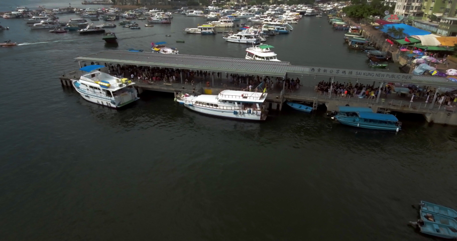 Aerial shot of boats picking up passengers at the Hong Kong Sai Kung pier