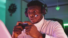Portrait shot of focused young black man professional game player playing video games. High quality 4k footage