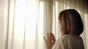 Woman opening white curtain at luxury hotel room - Powered by Shutterstock - Get 15% off with code: PIKWIZARD15