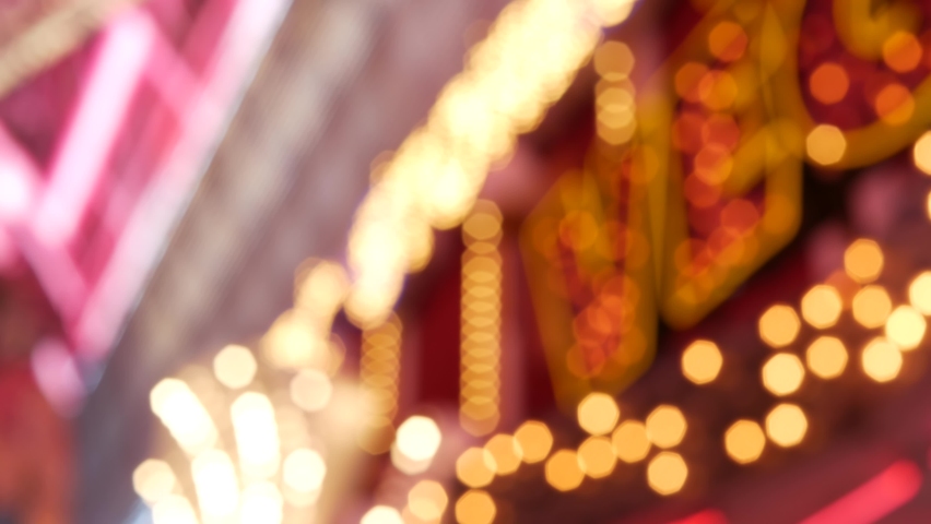 Defocused old fasioned electric lamps glowing at night. Abstract close up of blurred retro casino decoration shimmering, Las Vegas USA. Illuminated vintage style bulbs glittering on Freemont street. Royalty-Free Stock Footage #1061647051