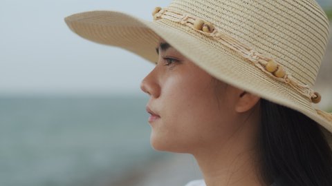Beautiful woman relaxing vacation fun summertime looking at ocean view. Close up of portrait female resting relax look at view while standing on the beach. Video Stok