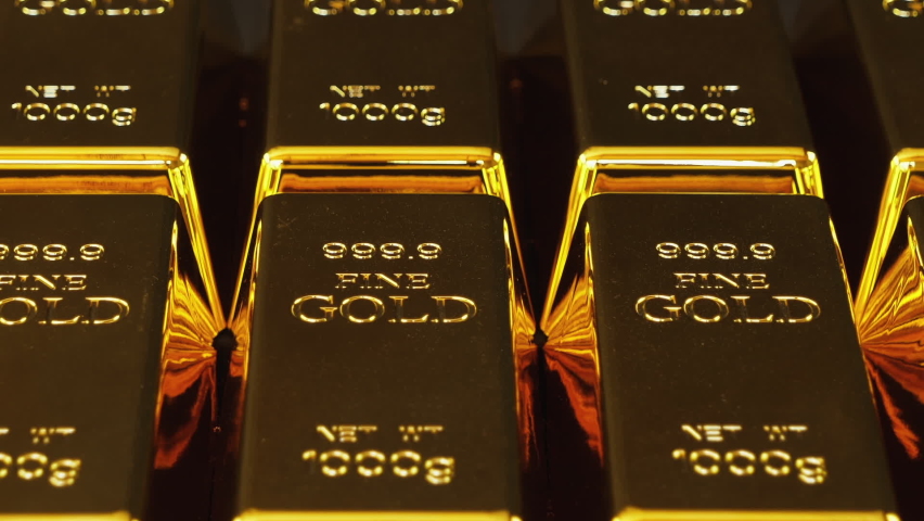 Gold bars stacked in a row. Gold bricks. Stack of gold bullion bars. Seamless looping footage. The camera pans around gold bars in close up. | Shutterstock HD Video #1061648014