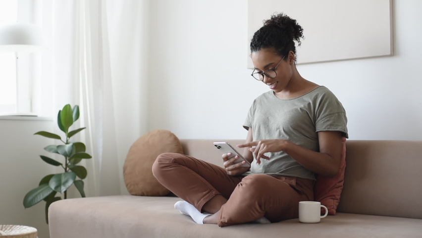 Woman using smartphone at home. Student girl texting on mobile phone in her room. Communication, work or study from home, connection, mobile apps, technology, lifestyle concept | Shutterstock HD Video #1061649778