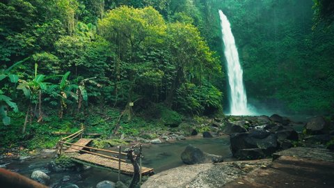 Amazing Nungnung waterfall hidden in tropical rainforest island Bali, Indonesia. 4K