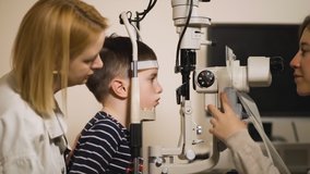 Optometrist checks kid's vision using modern opthalmology medical device - Powered by Shutterstock - Get 15% off with code: PIKWIZARD15