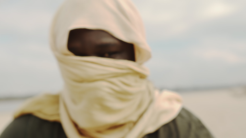 concept of terrorism. Unrecognizable black man shooting with kalashnikov, ak-47 machine gun