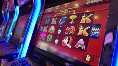 COQUITLAM , British Columbia / Canada - 11 10 2016: Coquitlam, BC, Canada - November 10, 2016 : Close up woman playing slot machine inside Hard Rock Casino with 4k resolution