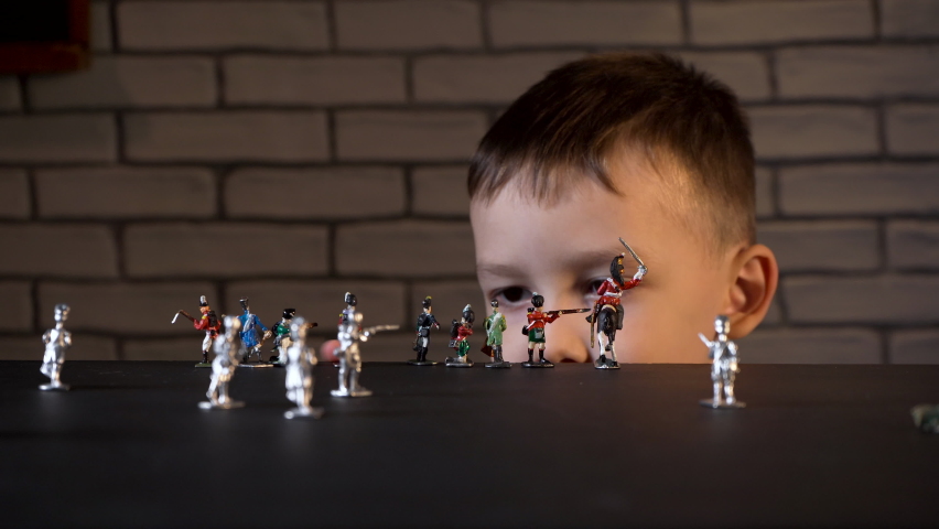 Video of four-year-old child playing with tin soldiers