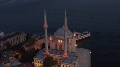 Illuminated Ortakoy Mosque from Above at Dusk, Aerial Birds Eye View perspective, Istanbul, Turkey on September 17th 2020