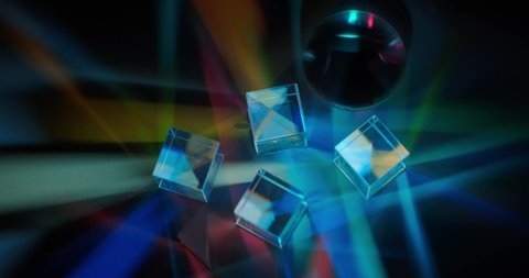 light rays pass through glass prisms and divide the light into rainbow colors of the spectrum