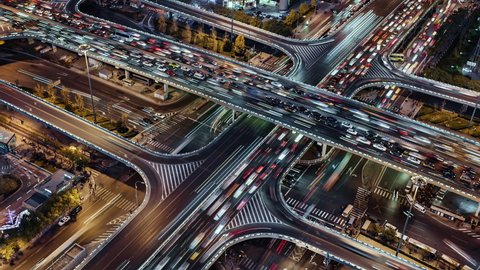 TL/ZO Asia, China, Beijing, 10-15-2019, Aerial view Zoom In Time lapse of busy road intersection in Beijing's financial district, with  traffic and commuters during evening rush hour