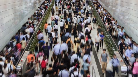TL/ Asia, China, Hong Kong, 11-12-2019, Zoom Out Time lapse of crowds of  people using underground subway during early morning rush hour in the Central financial district