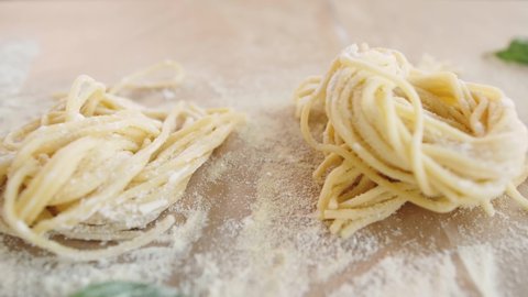 Home made pasta on the table with flour. Fresh pasta with wheat flour. Penne rigate Fresca pasta. Traditional italian food, high haute kitchen restaurant.