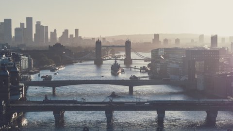 Establishing Aerial View Shot of London UK morning fog, amazing lights along the river, London Bridges, United Kingdom