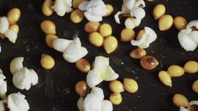 Close up of popcorn popping in a buttered pan - Powered by Shutterstock - Get 15% off with code: PIKWIZARD15