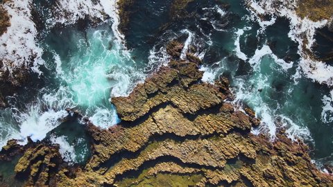 Cinematic aerial bird's eye view of tidepools at low tide in San Pedro, California