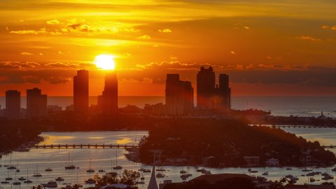 Time Lapse of the sun rising from behind the tall buildings on Miami Beach Florida