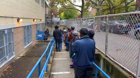Brooklyn, NY/United States - October 26, 2020:  African American people standing in long lines to vote early for a new president in the historic 2020 presidential election during a Covid-19.