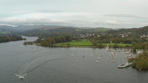 drone shot of speedboat coming out of the harbour near lake windermere