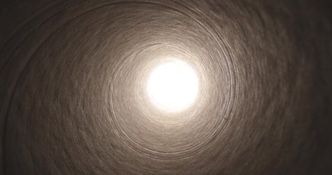 Moving through a tube tunnel with bright light shining at the end, probe lens motion