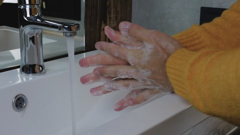 Wash Hands with soap under a tap with water, close-up. Body hygiene