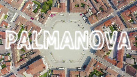 Inscription on video. Palmanova, Udine, Italy. An exemplary fortification project of its time was laid down in 1593. Neon white effect text, Aerial View, HEAD OVER SHOT with rotation