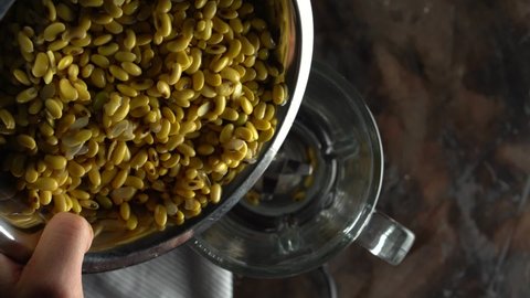 The chef puts soy beans in a blender. Raw soy seed food, organic texture on top, high in fiber, protein n healthy food, video.