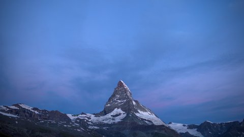 Time lapse forwards and backwards footage of clouds at sunrise above the mountain peak, Matterhorn, Alps